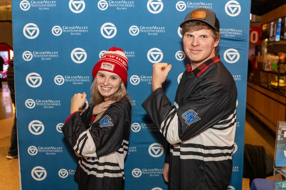 Two alums flexing their muscles.